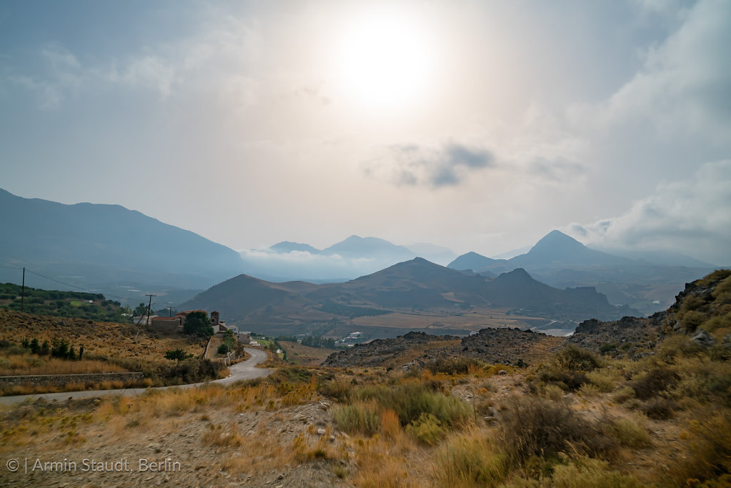 misty greek landscape with mountains and road