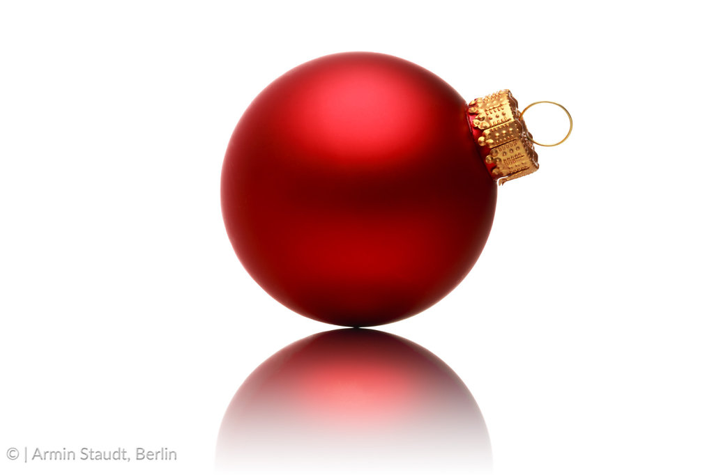 close up of a red christmas ball with reflection, isolated on white