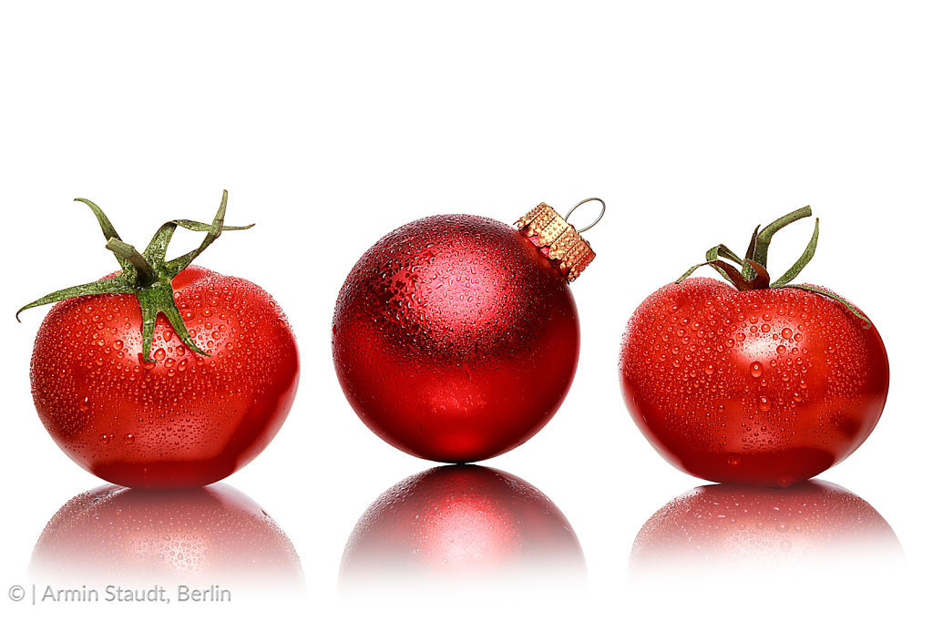 still life with two tomatoes and one red christmas ball, isolate