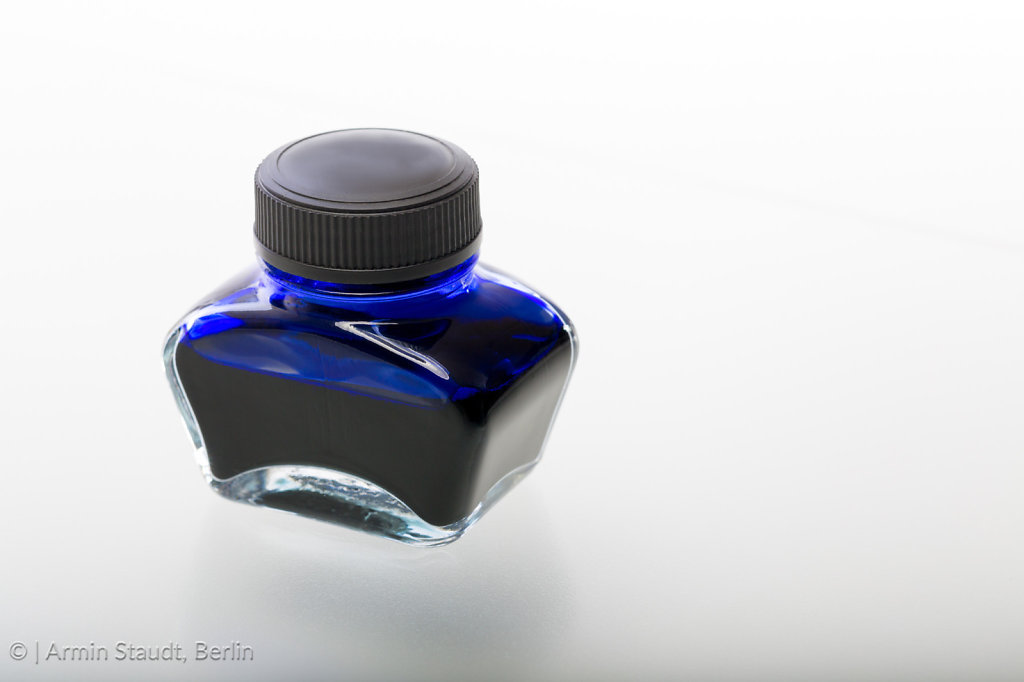 single blue glass ink pot, isolated on white