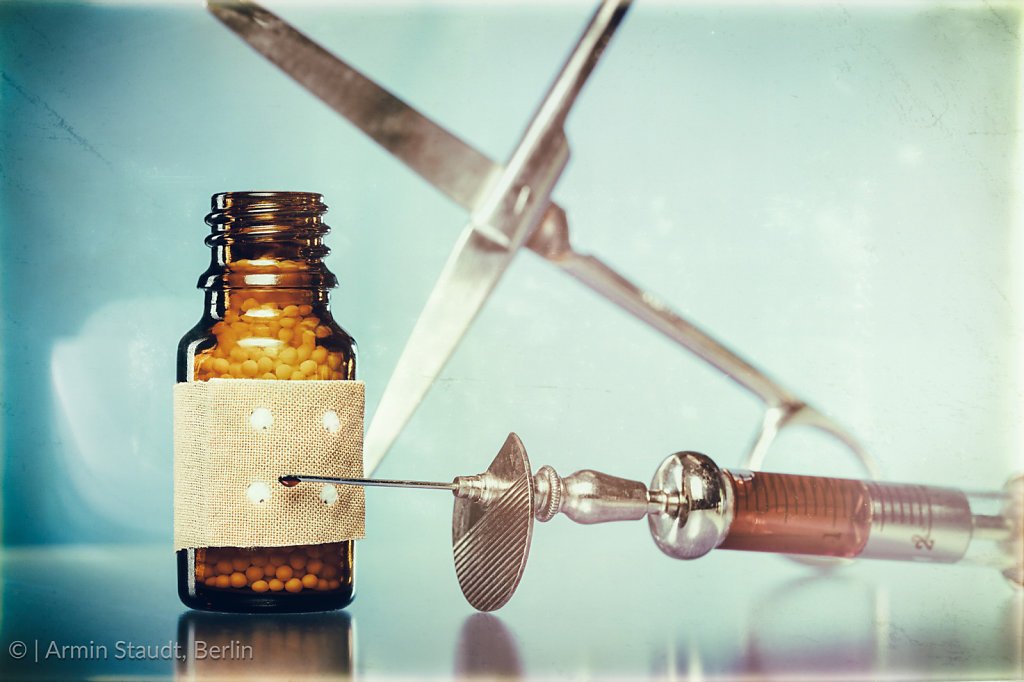 vintage still life with homeopathy globules. syringe with blood,  plaster and scissors