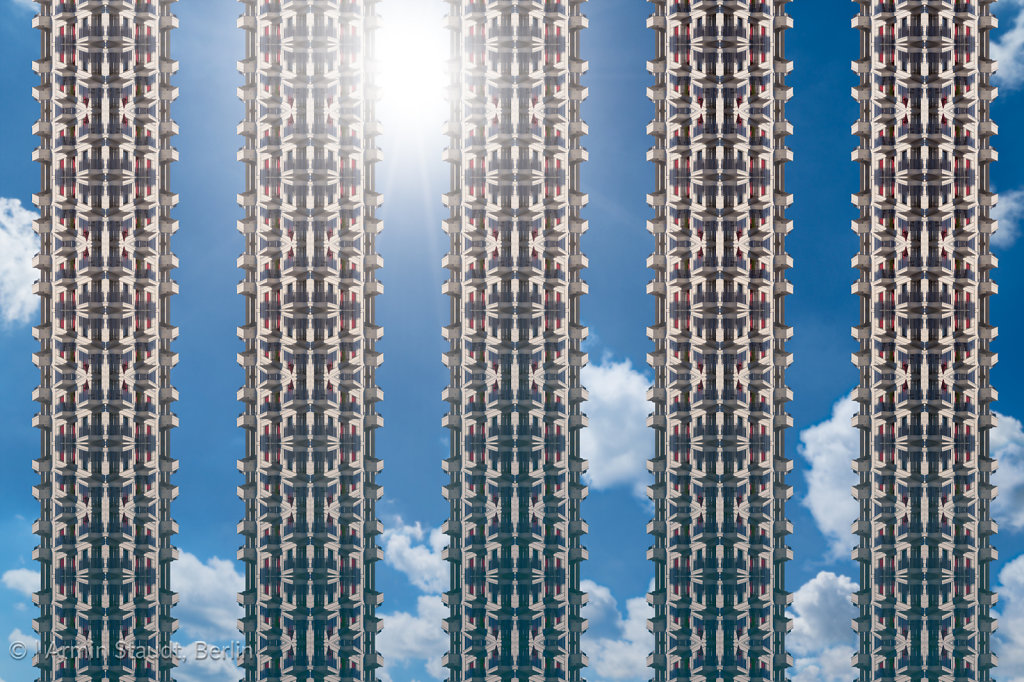 architectural pattern, the sun behind five artificial skyscrapers