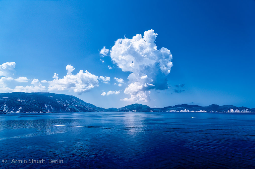 ocean landscape with mountain range and dramatic clouds