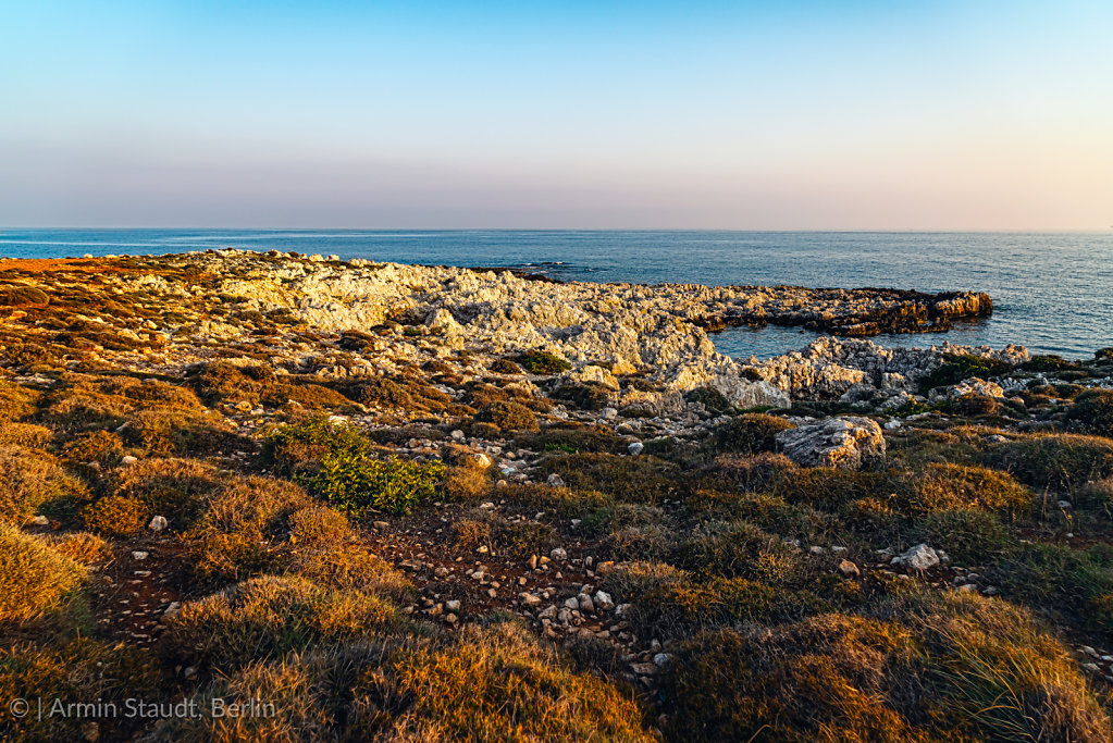 mediterranean landscape with rough rocks and ocean