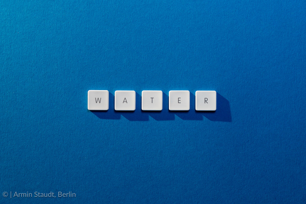 description of the word Water on a blue background